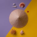 Asian hat with seashells on creative background