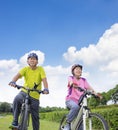 Asian healthy senior couple exercising with bicycles