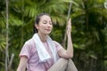 Asian healthy woman exercise and doing meditation of yoga on exercise mat in the morning exercise in the park. -  fitness, sport, Royalty Free Stock Photo