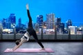 Asian healthy woman practicing yoga on the carpet at terrace