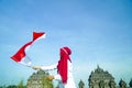 Asian Hijab flapper Indonesian flag with clear blue skyand Plaosan Temple background, Indonesia independence day Royalty Free Stock Photo