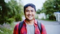 Asian hiker man trekking in forest. Young happy backpack male smiling to camera, travel nature and adventure trip, climb mountain