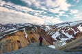 Asian hiker woman standing on top of volcanic mountain named Blanhjukur trail in summer at Landmannalaugar