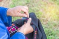 Asian hill tribe woman embroidering traditional pattern handcraft local clothes with needle