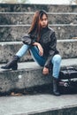 Asian hipster girl with fashionable brown leather jacket