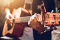 Asian hipster man left hand catch chord and playing music.