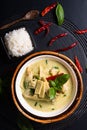 Asian home cooking Concept Thai chicken and baby bamboo Green curry and rice on black background with copy space