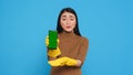 Asian homemaker holding chroma key mock up mobile phone with greenscreen display
