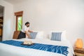 Asian hotel maid setting up pillow on bed sheet in hotel room Royalty Free Stock Photo