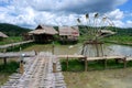 Asian house and water wheel in Southeast Asia. Royalty Free Stock Photo