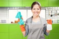 Asian housekeeper holding spray bottle and rag Royalty Free Stock Photo