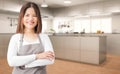 Asian housekeeper in kitchen Royalty Free Stock Photo