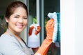 Asian housewife cleaning on window glass