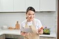 Asian housewife cooking in the kitchen Royalty Free Stock Photo