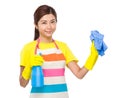 Asian housewife with detergent spray and towel