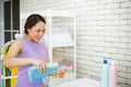 Asian housewife is measuring the laundry detergent Royalty Free Stock Photo