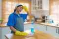 Asian housewife is tired of wiping the table in the kitchen at home Royalty Free Stock Photo