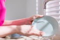Asian housewife wash dishes Royalty Free Stock Photo