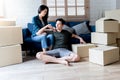 Asian husband Sitting on the floor with his attractive wife massaging his shoulders Royalty Free Stock Photo