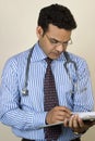 Asian Indian Doctor writing a report