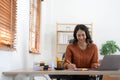 Asian indian Female director working in the office sitting at a desk analyzing business statistics holding diagrams and Royalty Free Stock Photo