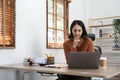 Asian indian Female director working in the office sitting at a desk analyzing business statistics holding diagrams and Royalty Free Stock Photo