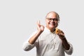 Asian Indian old man eating pizza with funny expressions Royalty Free Stock Photo