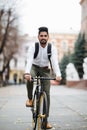 Asian indian riding bicycle in urban city street with speed and hipster trendy transportation