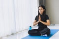 Asian indian woman doing buddha ways meditation yoga for mental health care at home
