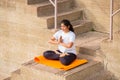 Asian Woman doing outdoor yoga tree pose meditation exercise, mental peace Fitness and health concept