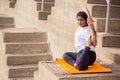 Asian Indian Woman doing yoga stretching exercise outdoor, body Fitness and health concept