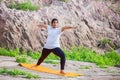 Asian Indian Woman doing yoga stretching exercise outdoor, body Fitness and health concept