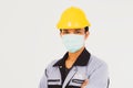 Male workers wear safety helmets and pay attention to wearing masks to prevent covid-19.