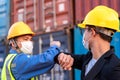 Asian industry construction site worker and foreman wearing hygiene face mask elbow bump greeting adaptation to prevent