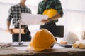 Asian industry professional team., Engineer teams meeting working together wear worker helmets hardhat on construction site Royalty Free Stock Photo