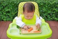 Asian infant baby boy eating by Baby Led Weaning BLW. Finger foods concept Royalty Free Stock Photo