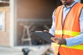 Asian inspector checking structure of new property and taking note in the clipboard for review and fix the house. Royalty Free Stock Photo