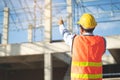 Asian inspector checking structure of new property and taking note in the clipboard for review and fix the house before sell. Royalty Free Stock Photo