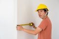 Asian Interior engineer measure new house wall Royalty Free Stock Photo