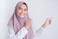 Asian Islam Muslim woman wearing headscarf is pointing finger to blank copy space smile face area. Indonesian woman. Religion Royalty Free Stock Photo