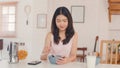 Asian Japanese woman has breakfast at home. Young Asia girls feeling happy drink juice, corn flakes cereal and milk in bowl on