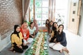 Asian javanese traditional eating together sitting on floor