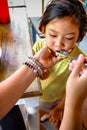 Asian Kid Being Feed Lunch Meals by His Mother in A Restaurant