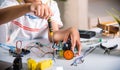 Asian kid boy assembling the Arduino robot car homework project at home