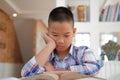 asian kid boy child stressed tired frustrated bored from studying. children with unhappy expression. Royalty Free Stock Photo