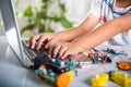Asian kid boy learns coding and programming with laptop for Arduino robot car Royalty Free Stock Photo