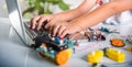 Asian kid boy learns coding and programming with laptop for Arduino robot car Royalty Free Stock Photo