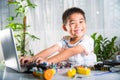 Asian kid boy learns coding and programming with laptop for Arduino robot car Royalty Free Stock Photo