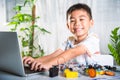 Asian kid boy learns coding and programming with laptop for Arduino robot car