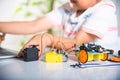 Asian kid boy learns coding and programming with laptop for Arduino robot car